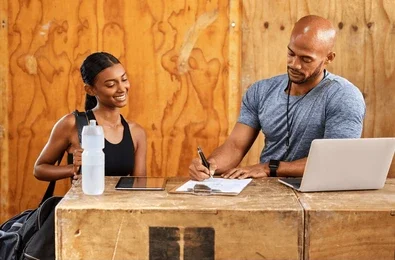 Certified personal trainer designing custom workout plans at Lumolog