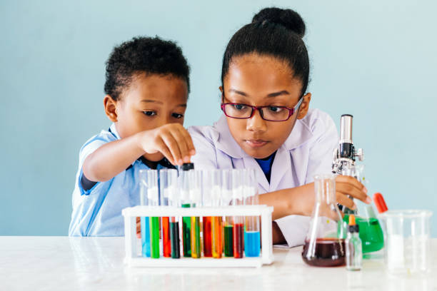 Children engaged with STEM experiment kits for hands-on science learning.