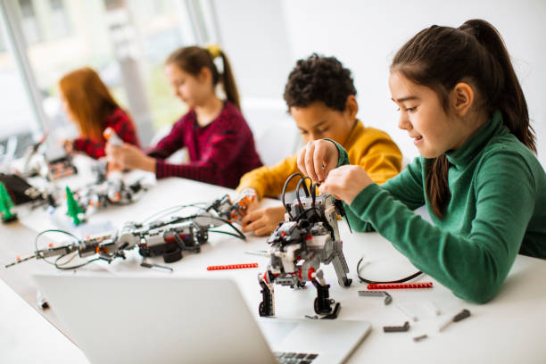 Young children exploring STEM experiment kits and interactive toys together.