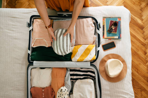 Person packing smartly using Lumolog travel tips.
