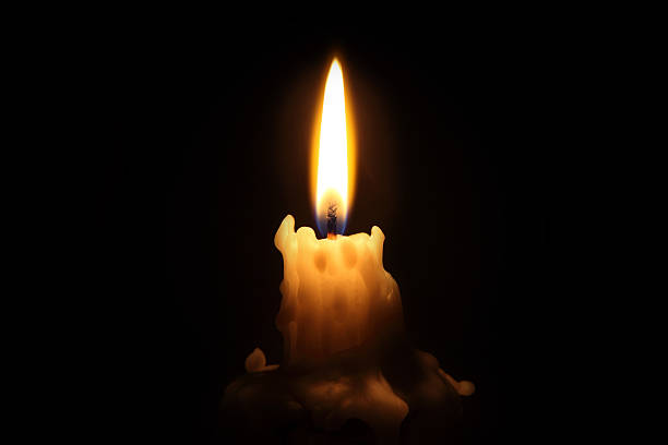 Sparkspitter candle with metallic wick glowing and producing soft spark effects